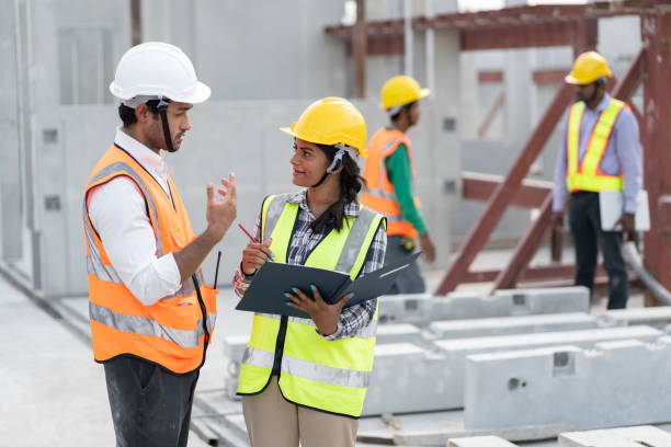istock India engineer woman and Asia engineer man working with document at precast site work 1483864662