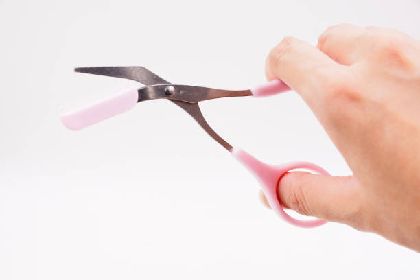 istock Pink eyebrow trimming scissors with comb remover 1483865576