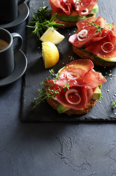 istock Avocado toast with bresaola (smoked meat). 1483867350