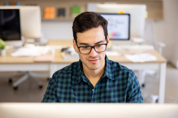 istock Business man working on his computer at a coworking office 1483869283