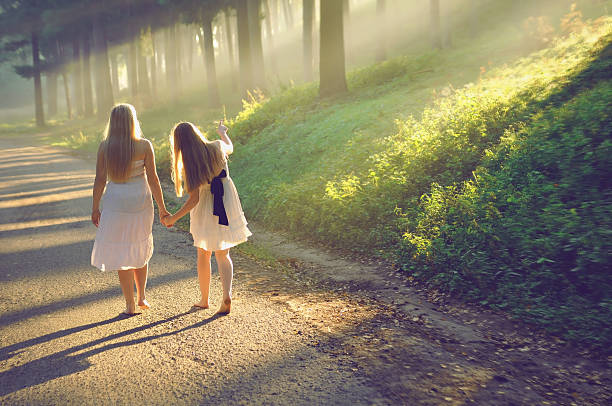 istock mother and daughter walking in the forest 148387293