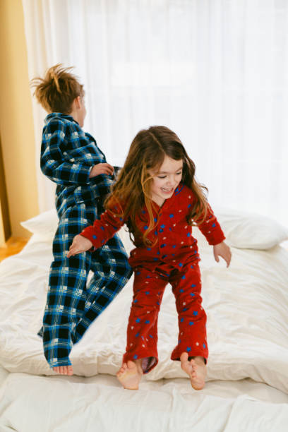 istock Children having fun jumping in the bedroom 1483874937