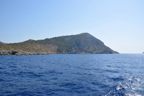 istock The island isolated with the blue sea is on foreground, copy space 1483875004