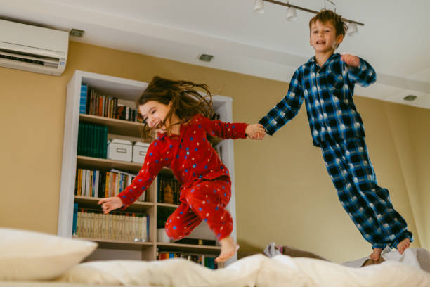 istock Children having fun jumping in the bedroom 1483875079