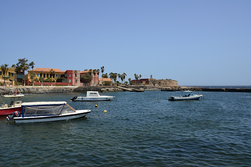 Gorée Island, Dakar, Senegal: leisure boats in the harbor, located on the east coast, buildings along Hesse Street, André Brue pier and Estrées Fort.