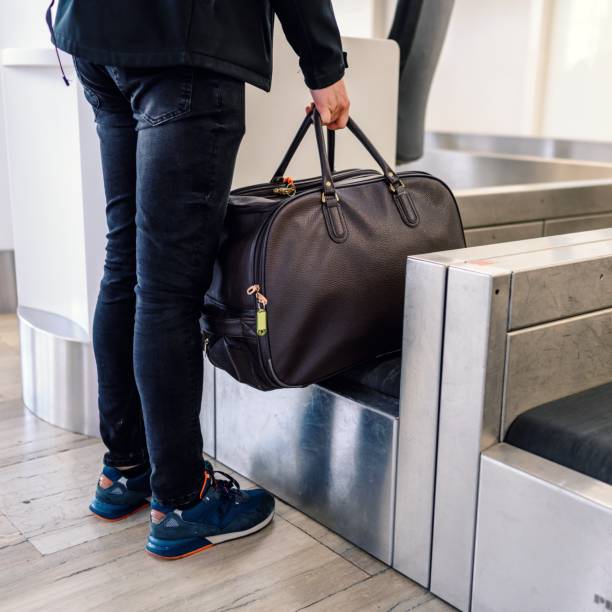 Luggage on weight at check-in counter at airport stock photo
