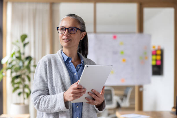 istock Businesswoman using a digital tablet while working at the office 1483885238