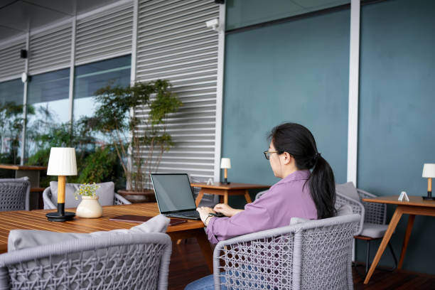 istock Asian women work on laptops outside coffee shops 1483887037