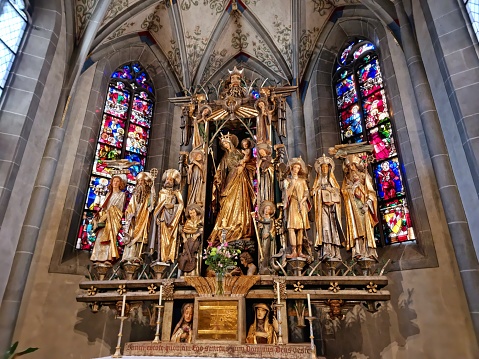 The richly decorated Gothic “Doorway of Kings” is the entrance to one of the most significant late-Gothic church buildings in Switzerland (built in 1478), with its plain elegant interior. The baroque Bossard organ and the original choir stalls are particularly worth seeing. The image shows the altar in the main nave of the church.