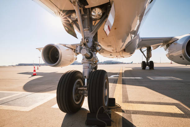 Low angle view of airplane at airport Low angle view of airplane at airport. Preparation passenger plane before flight during sunny summer day. aerospace industry stock pictures, royalty-free photos & images