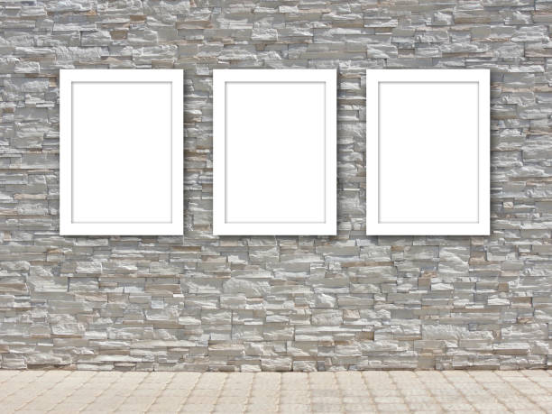 Three white frame templates on a decorative stone wall. stock photo