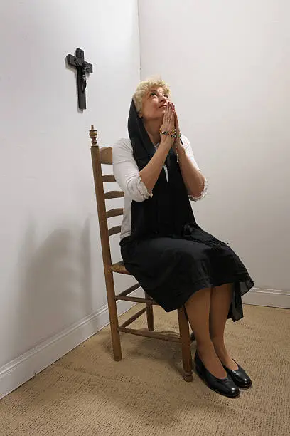 Photo of praying senior woman