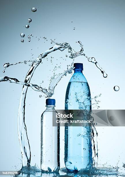 Bottles With Mineral Water And Splash Around It Stock Photo - Download Image Now - Abstract, Blue, Bottle