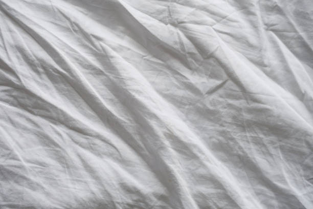 istock Wrinkled white linen texture. Creased fabric background. 1483904415