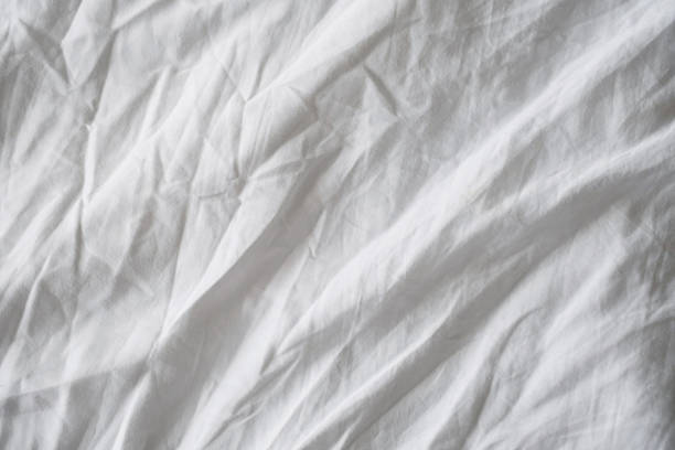 istock Wrinkled white linen texture. Creased fabric background. 1483904423