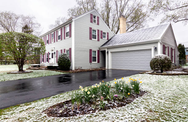 Springtime Snowfall Springtime garden covered in an April snowfall driveway colonial style house residential structure stock pictures, royalty-free photos & images