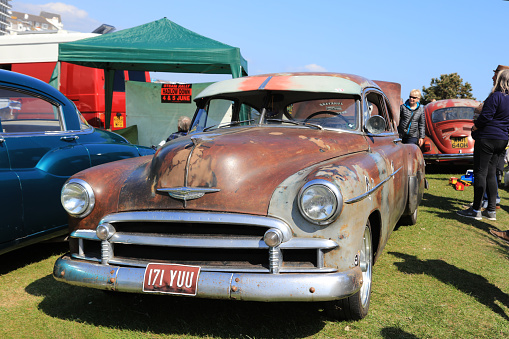 Matthews, North Carolina -  September 3, 2018: Visitors admire vintage 1950s era Chevrolet and Ford cars parked on display at the Matthews Auto Reunion