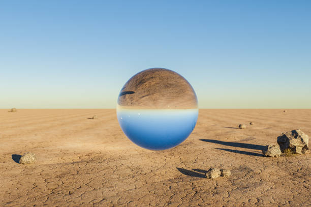 istock single glas sphere ball hovering in the air in large empty desert environment; abstract surreal concept; 3D Illustration 1483906008