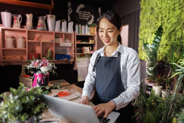 istock A flower vendor is using laptop at her small shop 1483906243
