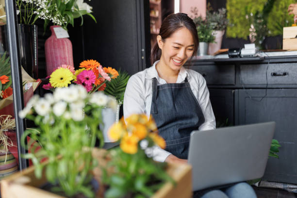 istock A flower vendor is using laptop at her small shop 1483907561