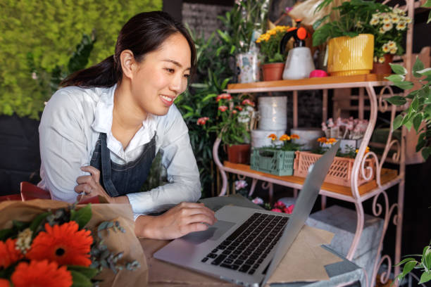 istock A flower vendor is working on the laptop 1483907764