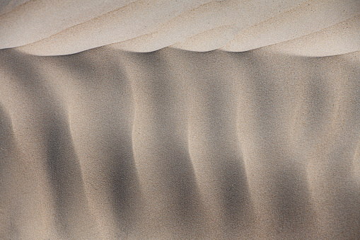 Abstract pattern in the sand on the beach.