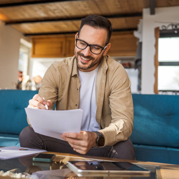 istock Man mature caucasian male work at home hold contract document smile 1483914578