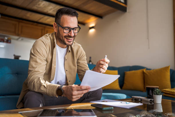 istock Man mature caucasian male work at home hold contract document smile 1483914579