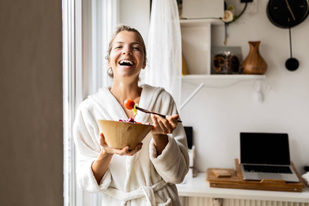 istock Young woman enjoying a delicious salad looking at camera 1483916021