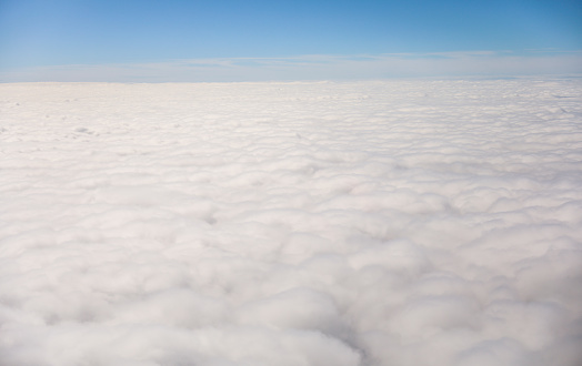 An airplane view of clouds symbolizes freedom, imagination, and perspective. The vast expanse of the sky inspires awe and wonder, offering a sense of detachment from the daily grind