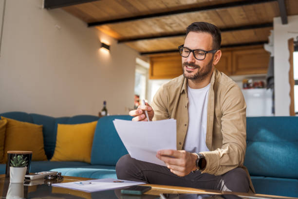 istock Man mature caucasian male work at home hold contract document 1483916969