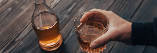 istock men holding a glass of whiskey 1483921802