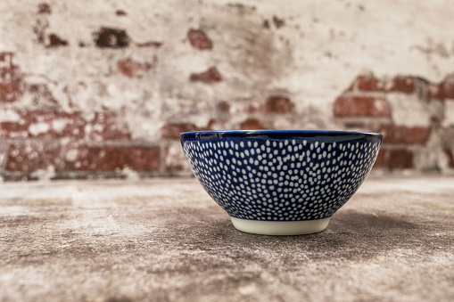 Nice empty blue porcelain bowl on gray surface