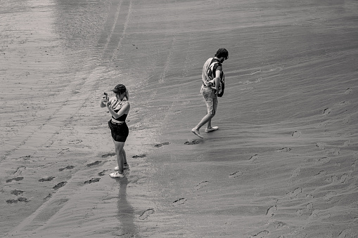 Siena, Italy - August 16 2022:Tourist Taking Mobile Phone Picture on the Rainy Wet Race Trock of the Palio di Siena on the Piazza del Campo