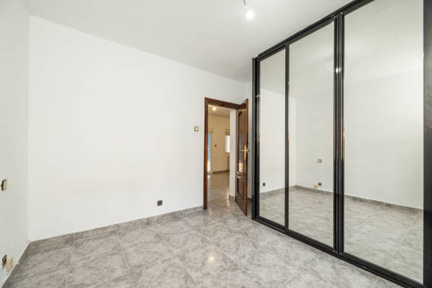 istock An empty bedroom with a custom-made wardrobe with sliding mirror doors 1483923881