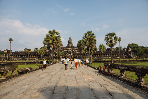 Group of people walking into Angkor War in Siem Reap, Cambodia