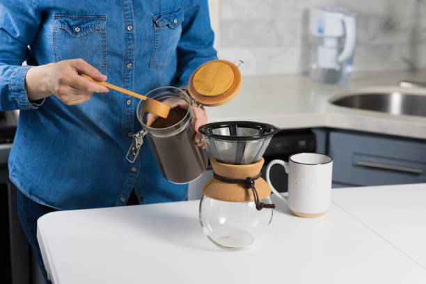 istock Woman making a pour over coffee at home 1483928102
