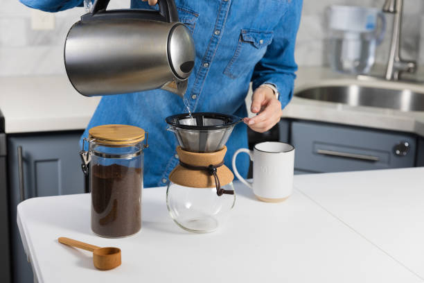 istock Woman making a pour over coffee at home 1483928136