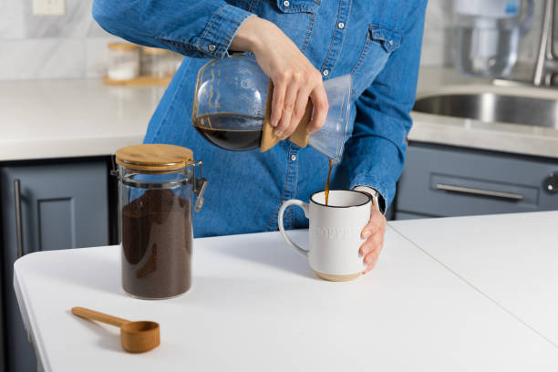 istock Woman making a pour over coffee at home 1483928156