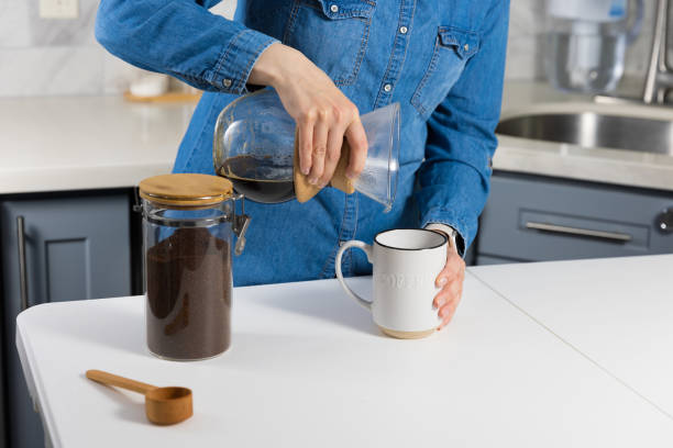 istock Woman making a pour over coffee at home 1483928169