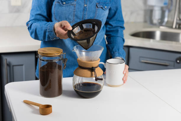 istock Woman making a pour over coffee at home 1483928178