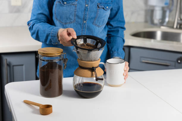 istock Woman making a pour over coffee at home 1483928189