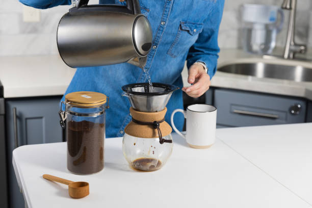istock Woman making a pour over coffee at home 1483928198