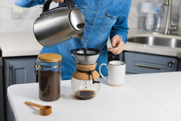 istock Woman making a pour over coffee at home 1483928218