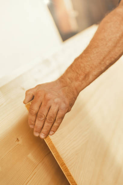 istock Strong hand lifts large wooden board 1483929898
