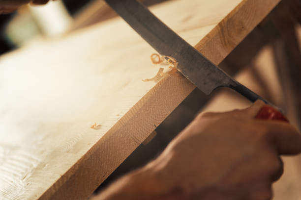 istock Chamfers and carves edges with drawknife 1483930838