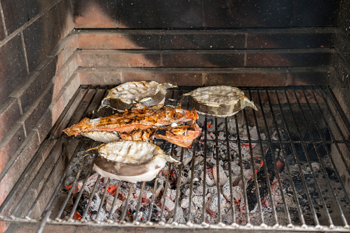 Close up of barbeque fishes on outdoors grill, Azores.