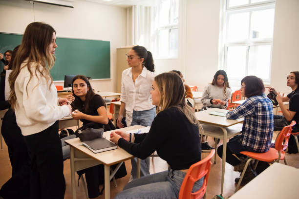 istock College students relaxing and taking a break in classroom. 1483933971