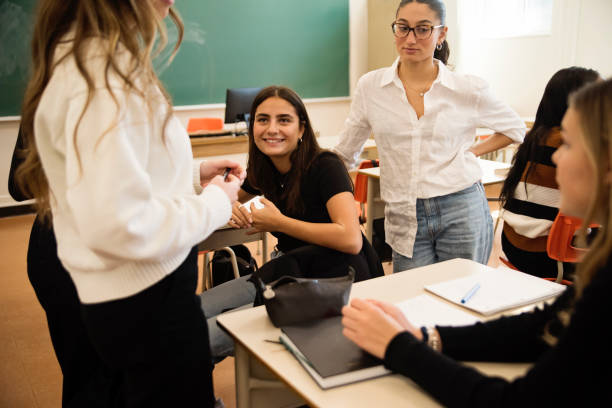 istock College students relaxing and taking a break in classroom. 1483934091