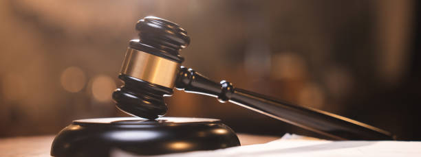 istock Judge gavel on the table with blurry books in the background 1483935409